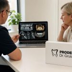 Dentist pointing at digital dental X-rays and 3D jaw scans on a laptop while consulting with a female patient in a bright office.