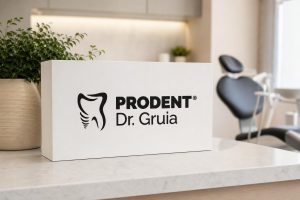 White box with the Prodent Dr. Gruia logo on a marble counter in a bright, modern dental clinic with a blurred treatment chair.