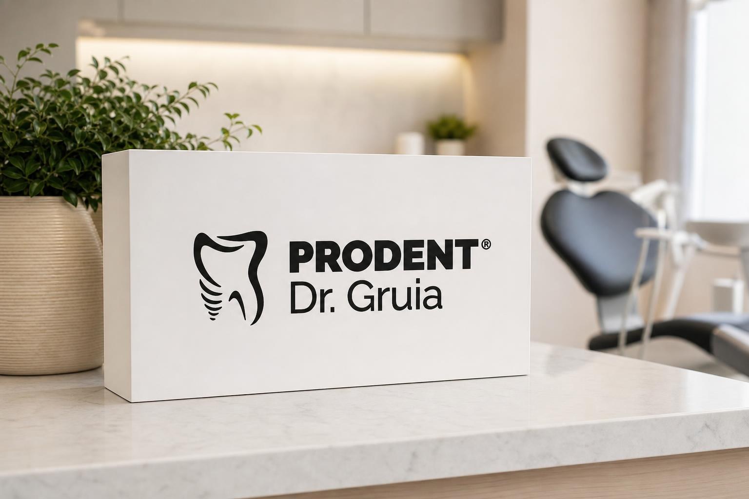 White box with the Prodent Dr. Gruia logo on a marble counter in a bright, modern dental clinic with a blurred treatment chair.