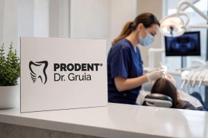 Prodent Dr. Gruia clinic sign in the foreground with a blurred dentist performing a procedure on a patient in a modern dental office.